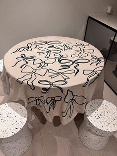 a round table with four stools in front of it