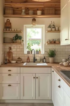 a kitchen filled with lots of white cupboards and counter top next to a window