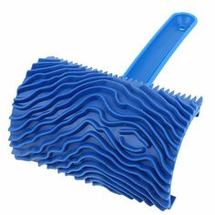 a blue dust mop with wavy design on the bottom and handle, against a white background