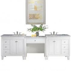 a white bathroom vanity with two sinks under a painting