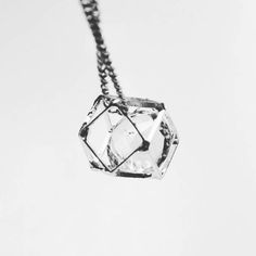 }}-------THE BASICS-------{{ A very cool geometric necklace for you or a loved one!  Whimsical and romantic! The geometric charm is a polyedron that encapsulates a crystal. The crystal floats in it's "cage" giving the sense of security! You'll cherish it! Also available in gold tone here: https://www.etsy.com/listing/238351676/gold-geometric-necklace-gold-diamond }}-------THE DETAILS-------{{ The chain is very dainty and it needs to be handled with care.  The charm is made of brass and there is a diamond shaped crystal floating freely inside. }}-------THE DIMENSIONS-------{{ The charm is 16x20x17mm approximately. The chain length is 20.5" (52cm) but I can make it longer or shorter upon request. It closes with a silver tone lobster clasp according to the chain color you choose. }}-------THE Modern Diamond White Necklace Gift, Diamond White Crystal Necklace For Gift, Diamond White Necklaces For Gifts, Diamond White Necklaces With Jewels For Gift, Hexagon Faceted Necklace For Gift, Silver Hexagon Necklace For Jewelry Making, Hexagon Faceted Necklace For Gifts, Modern Faceted Necklace As A Gift, Faceted Hexagon Necklace For Gift