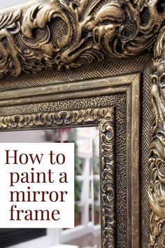 an ornate gold framed mirror sitting on top of a table next to a christmas tree