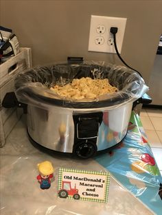 an old fashioned crock pot filled with macaroni and cheese on a table