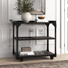 a shelf with books and wine glasses on it in front of a wall mounted mirror