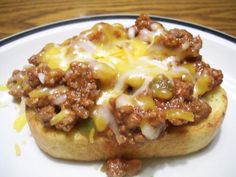 a close up of a plate of food with meat and cheese on it's crust