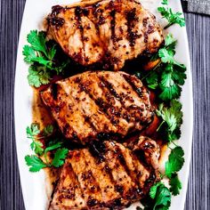 grilled pork chops and greens on a white plate