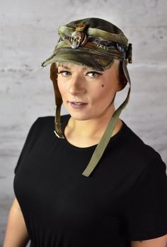 Postapoc Cap - Military Style Cap - Wasteland LARP Headpiece - Army Green Cap - LARP Accessories - Post Apocalyptic Hat - Handmade Headwear A unique post-apocalyptic styled cap. An olive green base, decorated with leather straps and stylish ear flaps. It's a unique costume piece that will add a spark of life to any military-style outfit! Finished with professional paintwork for a distressed effect, it has a very lifelike feel of a worn down headpiece. It's a one size product. More apocalyptic clothing: https://etsy.me/3Z2OHJ5 More accessories: https://etsy.me/2jskDVG MY ETSY SHOP: https://www.etsy.com/shop/WastedCouture Wear if you dare! --------------------------------------------------------------------- Wasted - Wasted Couture - WastedCouture Alternative Style Adjustable Cap, Adjustable Alternative Style Cap, Adjustable Punk Visor Hat, Adjustable Punk Style Visor Hat, Punk Style Adjustable Visor Hat, Alternative Adjustable Hat For Festivals, Adjustable Cap For Cosplay, Adjustable Military Hunting Hat, Military Style Adjustable Visor Hat