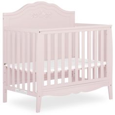 a pink baby crib with white sheets on the bottom and side rails, in front of a white background