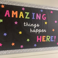 a bulletin board with colorful stars and the words amazing things happen here written on it