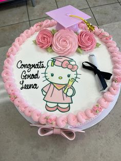 a hello kitty cake decorated with pink roses