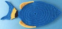 a crocheted blue and yellow fish on a blue background