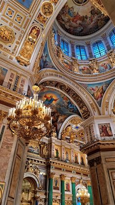 the interior of a church with chandeliers and paintings on the walls, ceiling