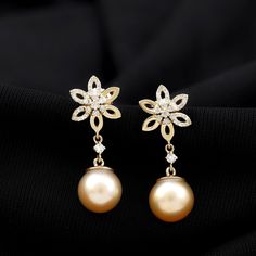 Product Details This Floral Pearl Drop Earrings embellished with Round Shape South Sea Pearl and small Round Shape Diamonds are set on the half flower in a Pave Setting, crafted in a Solid Gold. Product Information SKU SHP-EARRINGS122045753 Weight 2.24 gm (Approximate) SOUTH SEA PEARL INFORMATION No.of Stones 2 Pieces Total Weight 11.36 Carat (Approximate) Dimension(approx) Round-9X9 mm-2 Pcs Color Golden Cut Brilliant Shape Round Setting Type Bead-Set Quality Grade AAA DIAMOND INFORMATION No.of Gold Plated Round Flower Earrings For Wedding, Gold Plated Flower Earrings For Weddings, Gold Diamond Flower Earrings For Formal Occasions, Elegant Yellow Gold Flower-shaped Pearl Earrings, Formal Gold Diamond Flower Earrings, Elegant Yellow Gold Flower Pearl Earrings, Gold Flower Shape Bridal Earrings, Wedding Flower Earrings In 14k Yellow Gold, Elegant Gold Flower Shaped Pearl Earrings