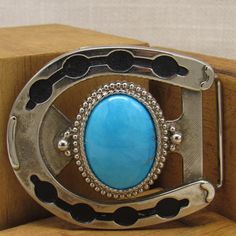 "Silver-tone horseshoe belt buckle with faux turquoise stone. 2 7/8\" wide x 3 1/4\" long. Fits a 1 3/4\" belt. Great western look. Good condition. Shipped by US first-class mail. *The color on your screen may not reflect the actual stone color due to monitor variations.* SBK-1" Adjustable Turquoise Western Belt Buckles, Blue Concho Western Belt Buckles, Western Style Blue Concho Belt Buckles, Horseshoe Belt, Buckles Western, Cool Belt Buckles, Cool Belt, Shoe Buckle, Wood Barn Door