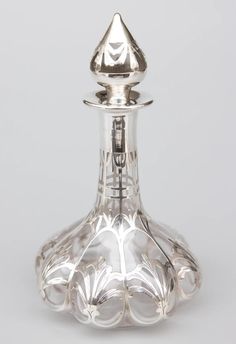 a silver vase sitting on top of a white table