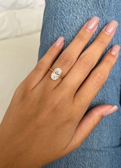 a woman's hand with a diamond ring on it