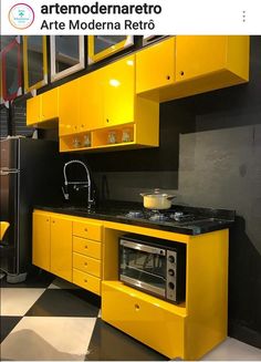 a kitchen with yellow cabinets and black counter tops in an industrial style home or office