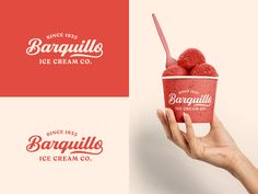 a hand holding up a cup of ice cream with raspberries on top and the logo for barquillis ice cream co