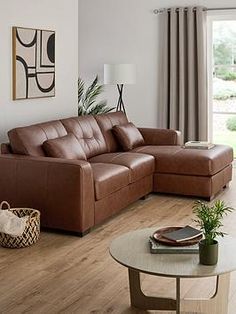 a living room filled with furniture next to a sliding glass door and wooden flooring