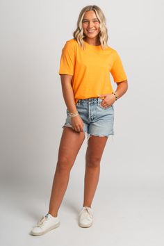 Basic short sleeve t-shirt from Lush Fashion Lounge women's boutique in Oklahoma City. Lush boutique in OKC has a variety of cute basic tops and more! This trendy basic t-shirt is a must have! Pair this basic orange top with shorts and sneakers for a cute and casual look! Model is 5'4 size 26 wearing size small. 100% cotton Top With Shorts, Basic Shorts, Orange Top, Women's Boutique, Basic T Shirt, Basic Tops, Oklahoma City, Ladies Boutique, Short Sleeve Top