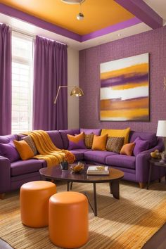 a living room with purple couches, orange and yellow pillows on the walls and rugs