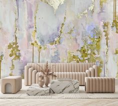 a living room scene with focus on the couch and coffee table in front of an artistic wallpaper