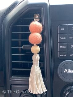 an air conditioner with two orange balls hanging from it