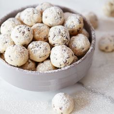 a bowl filled with cookies and powdered sugar