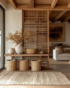 a living room filled with lots of furniture and baskets on top of a wooden table