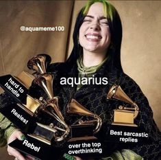 a woman with green hair holding several awards