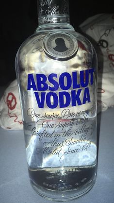 a bottle of absolut vodka sitting on a table