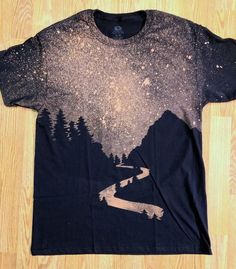 a t - shirt with trees and mountains on it