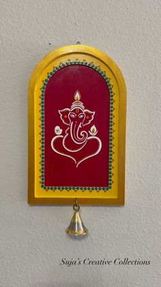 an ornate ganeshi decoration hangs on the wall