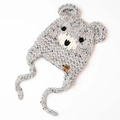 a crocheted hat with a teddy bear on the front and ear flaps