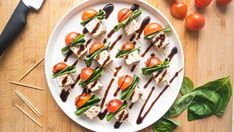 a white plate topped with lots of veggies on top of a wooden table