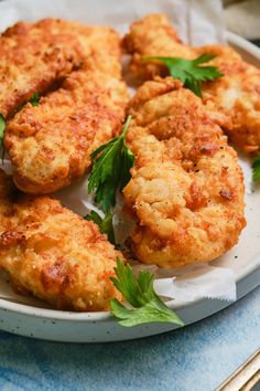 some fried food is on a plate with silverware