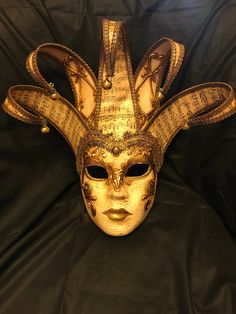 Hand-made papier-mâché mask, painted with acrylics, and embellished by gold-leaf, fabrics and stucco decorations. Full face mask, suitable for wearing or as home decor elements. Size: One-size. This mask ties in the back with two soft matching ribbons. Produced in Venice, Italy. More shapes available, both for men and women. We ship worldwide with GLS, DHL and Fedex, directly from Venice. Very Important PLEASE WRITE YOUR TELEPHONE NUMBER WHEN YOU COMPLETE YOUR ORDER: this is required by the ship Artistic Masks For Costume Party And Festivals, Artistic Masks For Festivals And Costume Parties, Artistic Full Face Masks For Mardi Gras, Traditional Theater Masks For Festivals, Traditional Masks For Theater And Festivals, Artistic Masquerade Mask For Festivals, Artistic Costume Masks For Festivals, Artistic Masks For Costume Festivals, Artistic Gold Masks And Prosthetics For Festivals