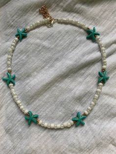 This handmade beaded necklace is perfect for summer or all year round. It has an adjustable chain, so that you can wear it as a choker or as a regular necklace. 10% of profits from this necklace go to the  Ocean Conservancy which works to help the ocean and create science based solutions to save the ocean and its wildlife. Starfish Beaded Necklace, Cute Beading Ideas, Ocean Necklace Beads, Cute Homemade Jewelry, Handmade Starfish Shell Necklace In Ocean Style, Handmade Starfish Necklace For Vacation, Handmade Starfish Shell Necklace, Ocean-inspired Style, Bohemian Starfish Shell Necklace For Summer, Starfish Necklace For Beach Season Gift