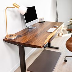 a wooden desk with a computer on it