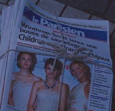 the newspaper is wrapped in twine and tied up with a string to show two women's dresses