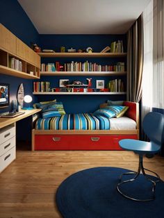 a bedroom with blue walls and wooden flooring, built - in bookshelves