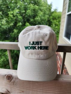 "Adult sized unstructured dad hat (buckleback adjustable closure 21\"-25\" circumference) (25 assorted colors) with \"I JUST WORK HERE\" embroidered on the front of the cap. If you have a font that you'd like or anything changed (i.e. change to cursive or not all caps) let me know, I'd be happy to customize it! :)  . . . If you would want anything changed, please make note of it in the order, I do most of these made to order so don't be afraid to customize it! :) All orders are made in the order I Just Work Here, Cap Designs, A Font, Shades Of Beige, Shirt Embroidery, Dad Caps, Cute Hats, Girl With Hat, Dad Hat