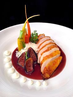 a white plate topped with meat and vegetables