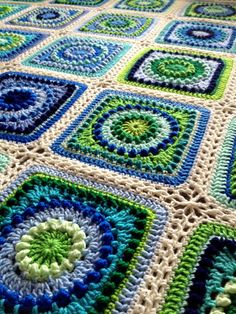 a crocheted blanket that is on the floor