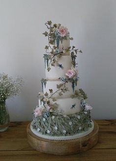 a three tiered wedding cake with flowers on it