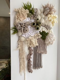 a wall hanging made out of yarn and flowers