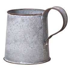 an old metal mug is shown on a white background, with the handle extended to hold something