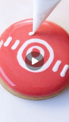 a red donut with white icing on it