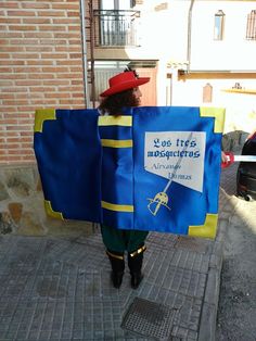 a woman is walking down the street holding a sign