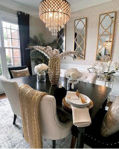 a dining room table with chairs and a chandelier